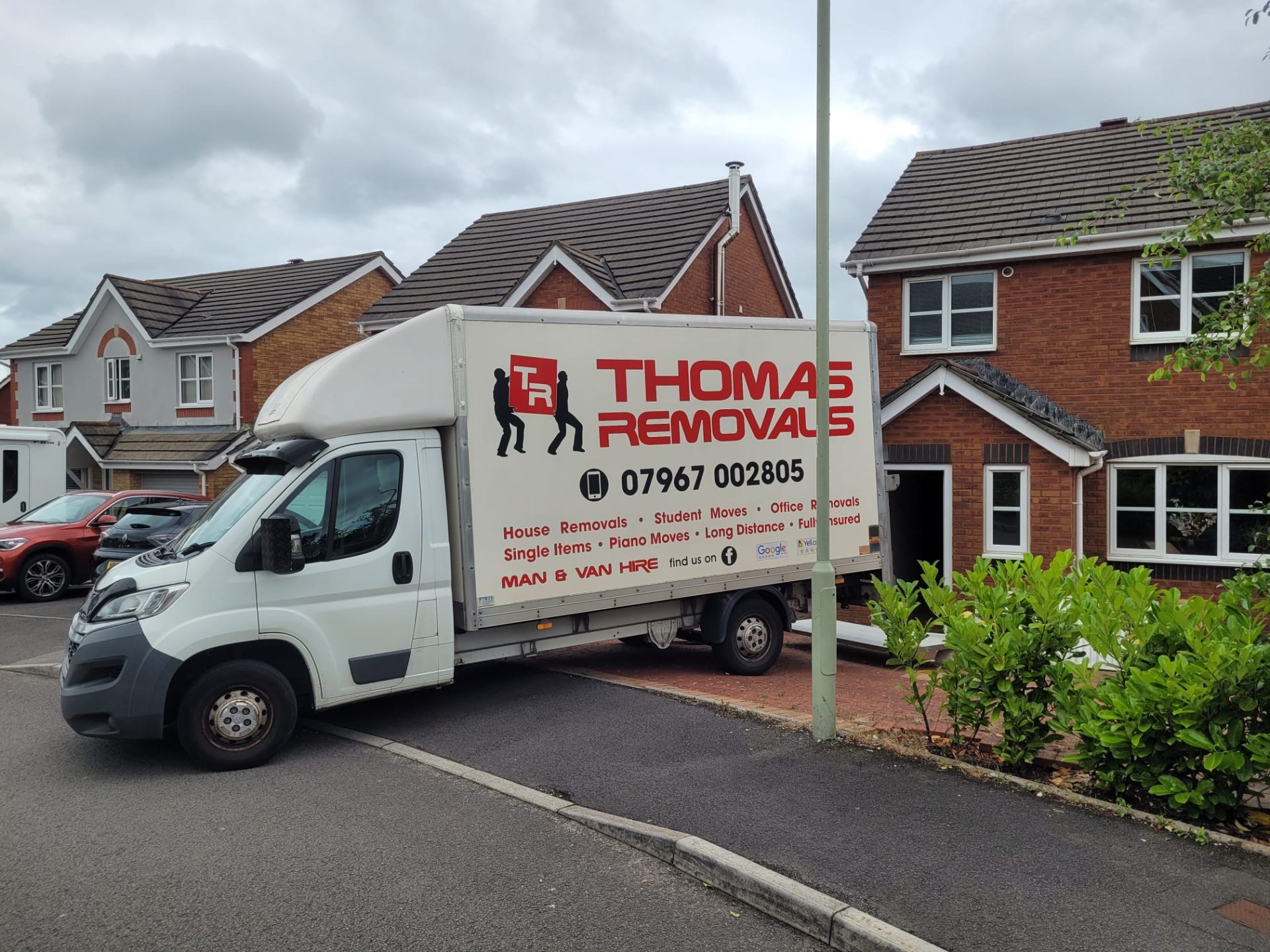 Thomas Removals van outside a residential home in South Wales during a house move