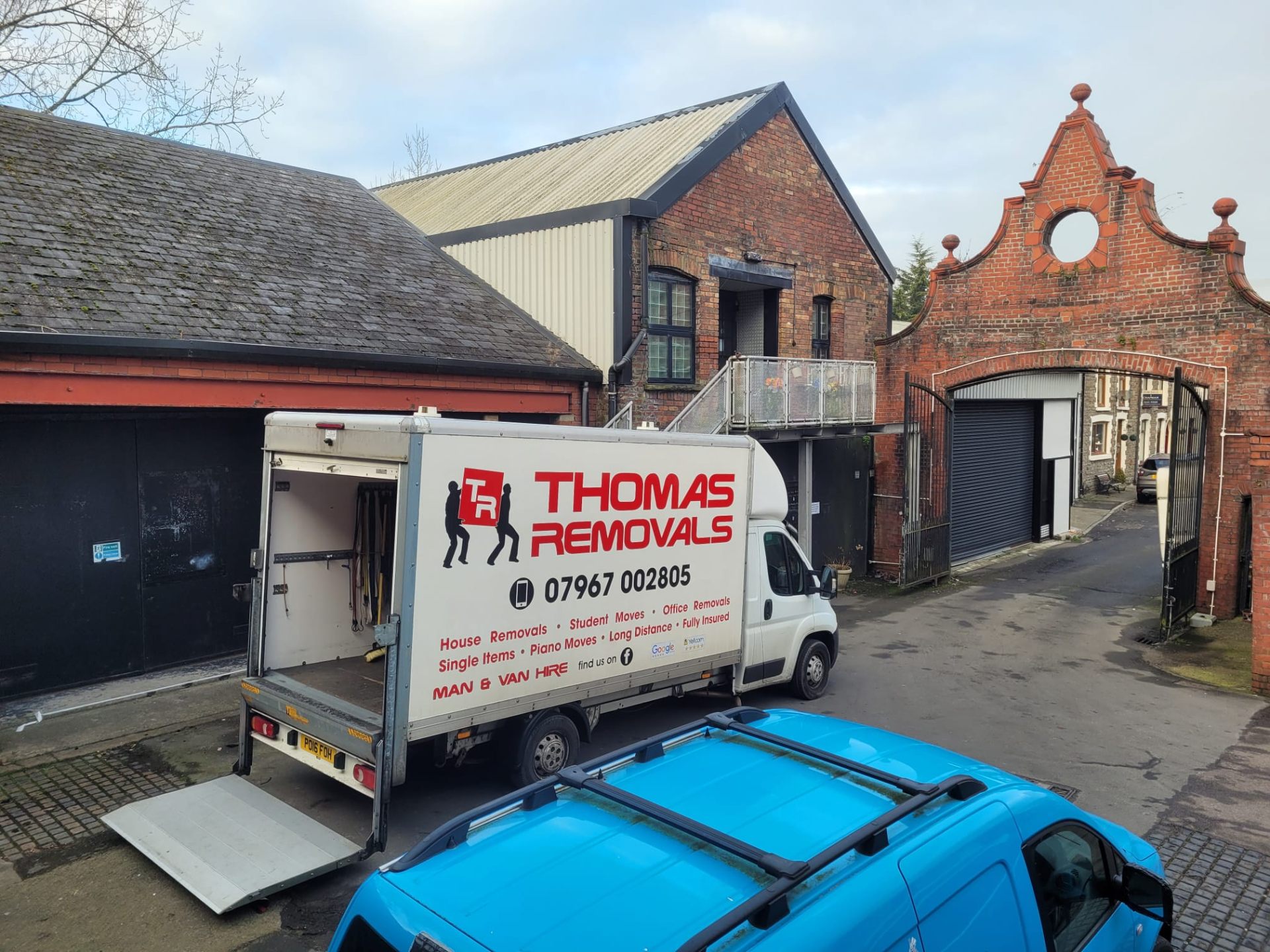 Thomas Removals van at a heritage brick building during an office removal