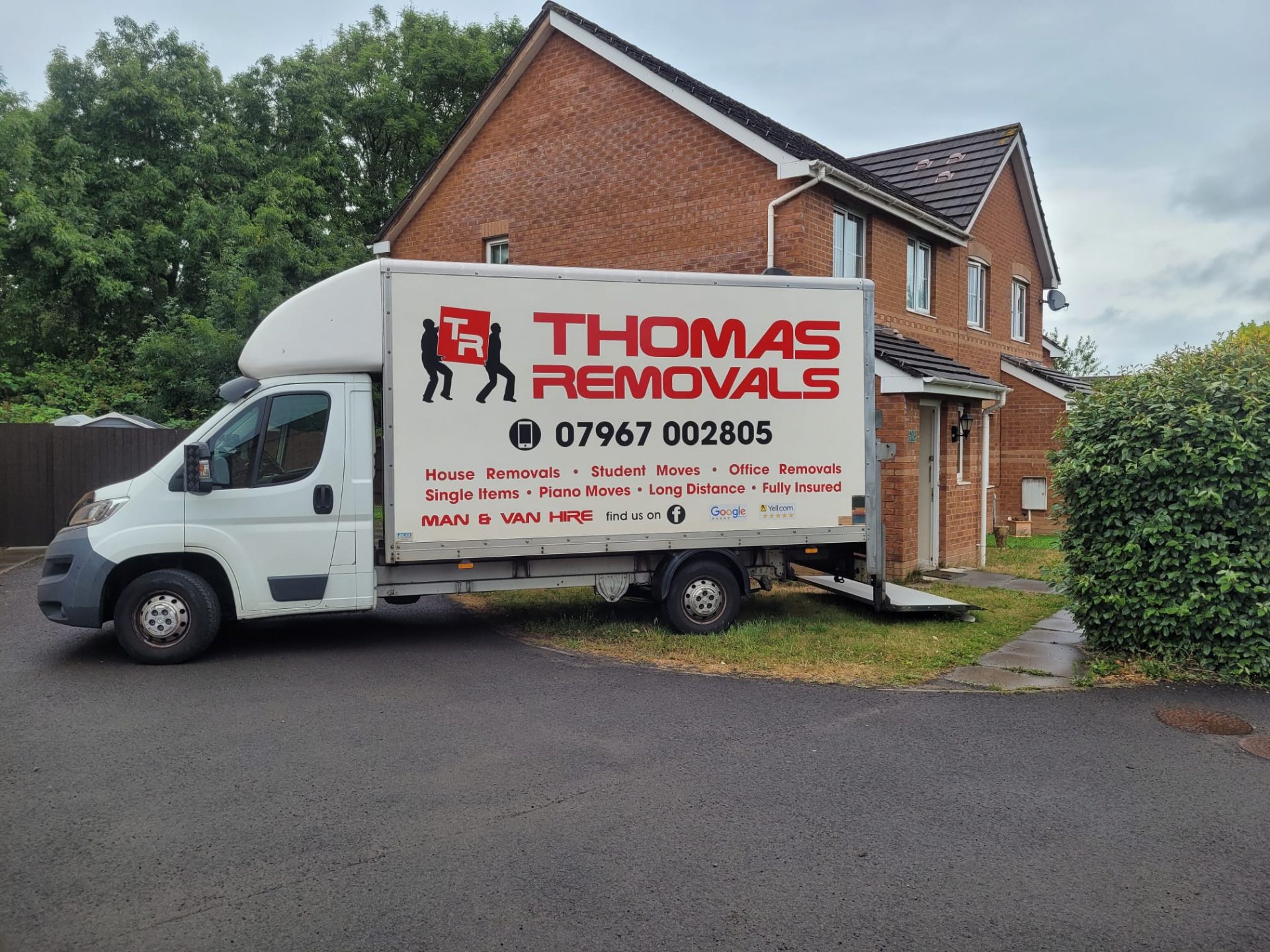 Thomas Removals van outside a detached house during a full home removal in Rhondda Cynon Taff
