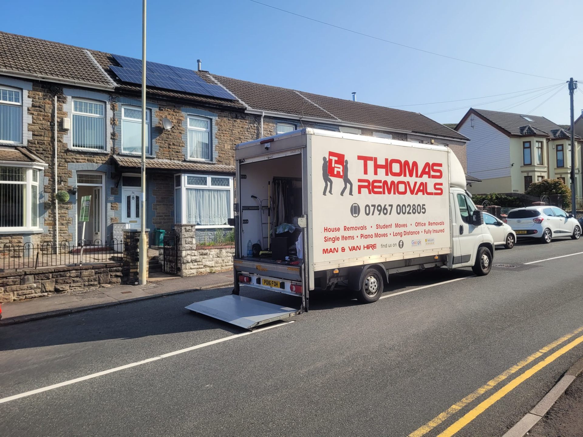 Thomas Removals van on a terraced street in Rhondda Valley during a house clearance