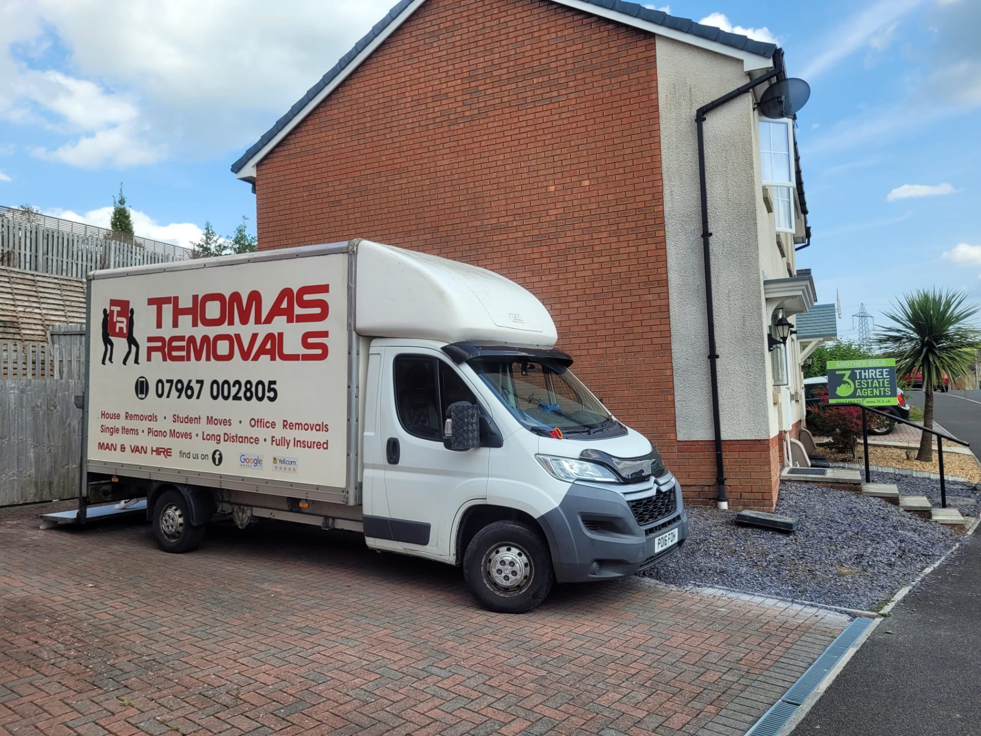 Thomas Removals van completing a delivery at a new-build estate in South Wales