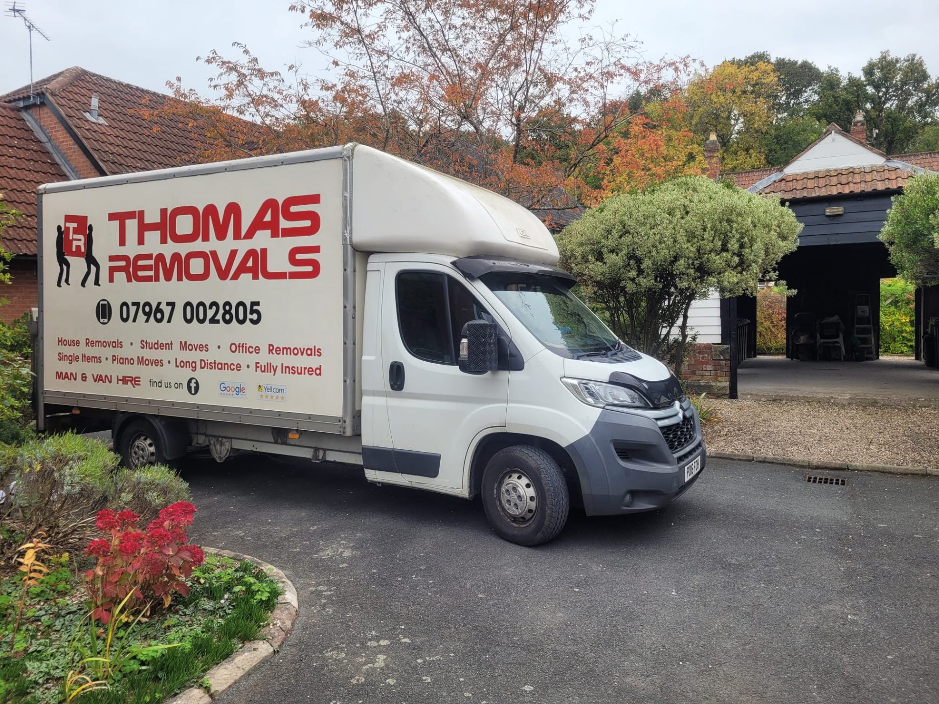 Thomas Removals van outside a country property during an autumn removal